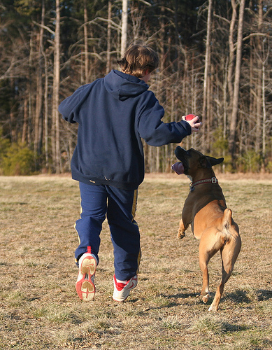 Boy running with dog